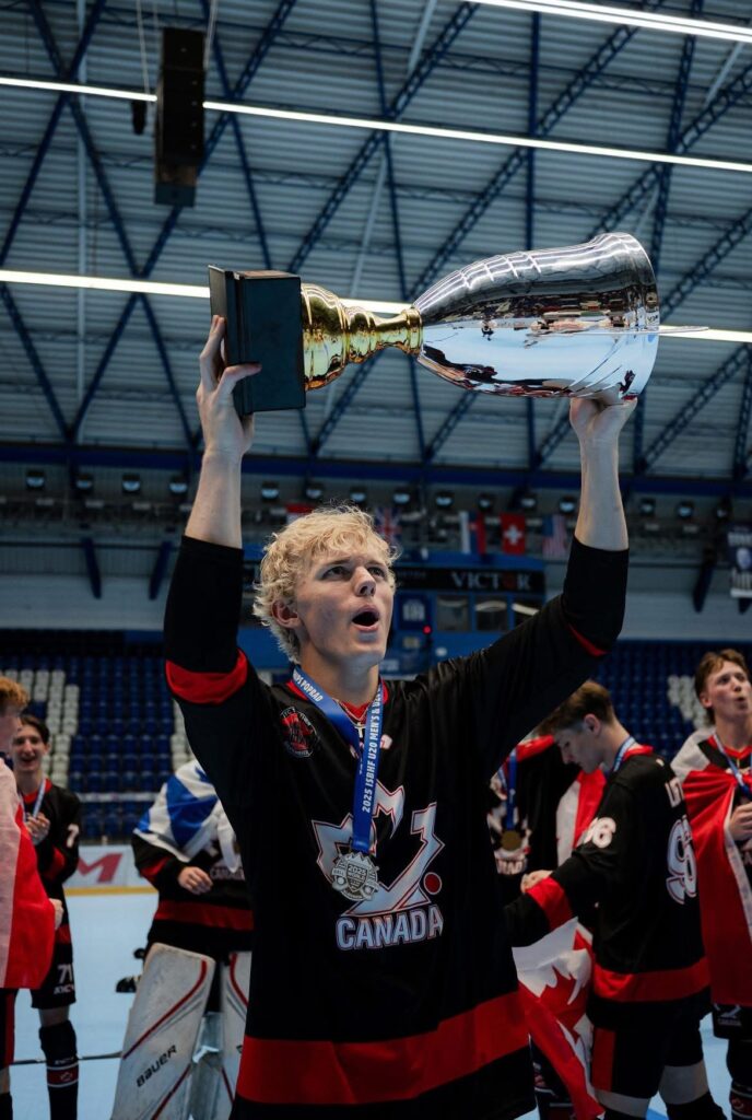 Nik Stang holding up the cup after winning Gold at the u18 worlds.